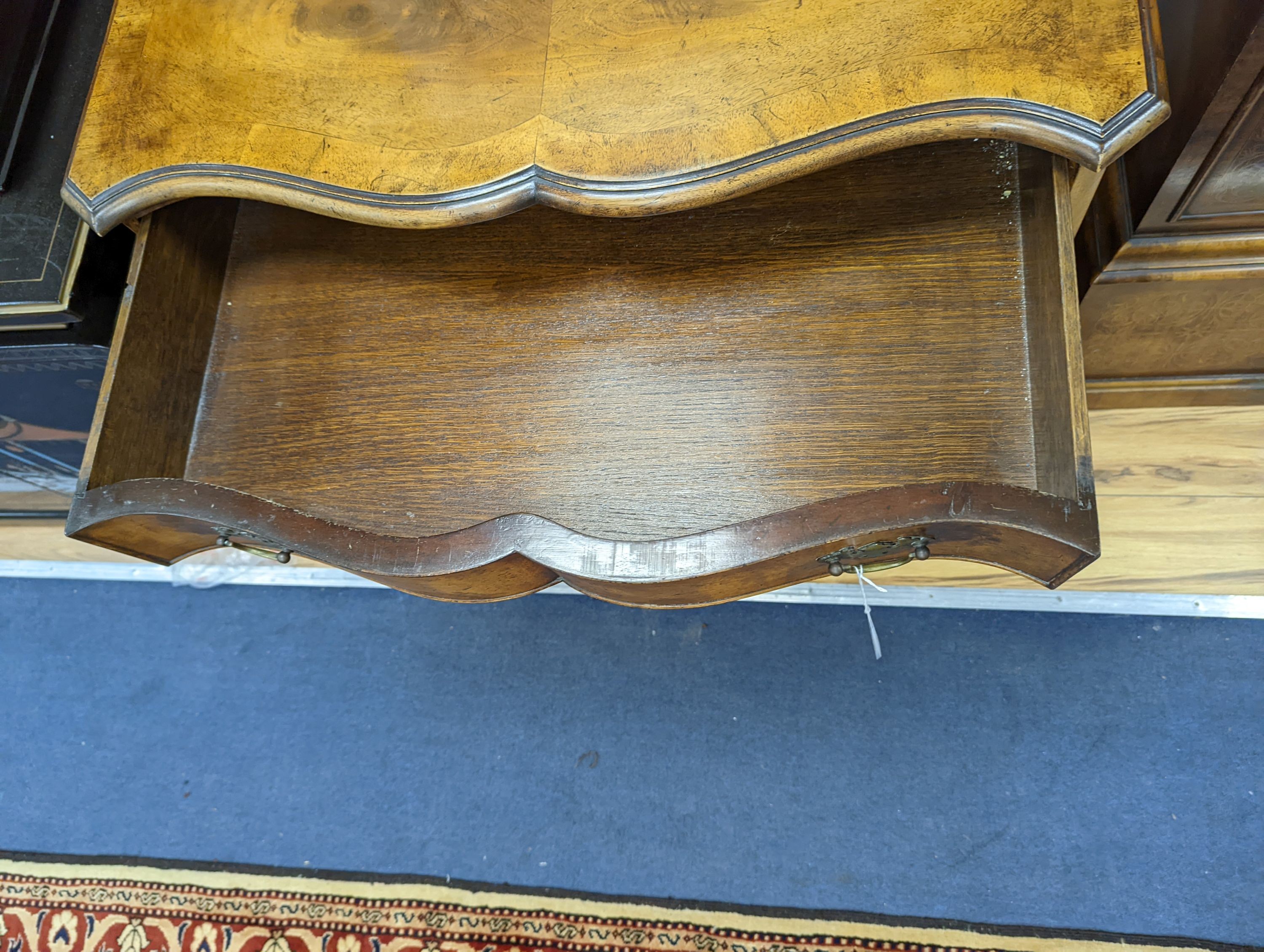 A 1920's Queen Anne revival banded walnut shaped front chest, width 76cm, depth 46cm, height 85cm